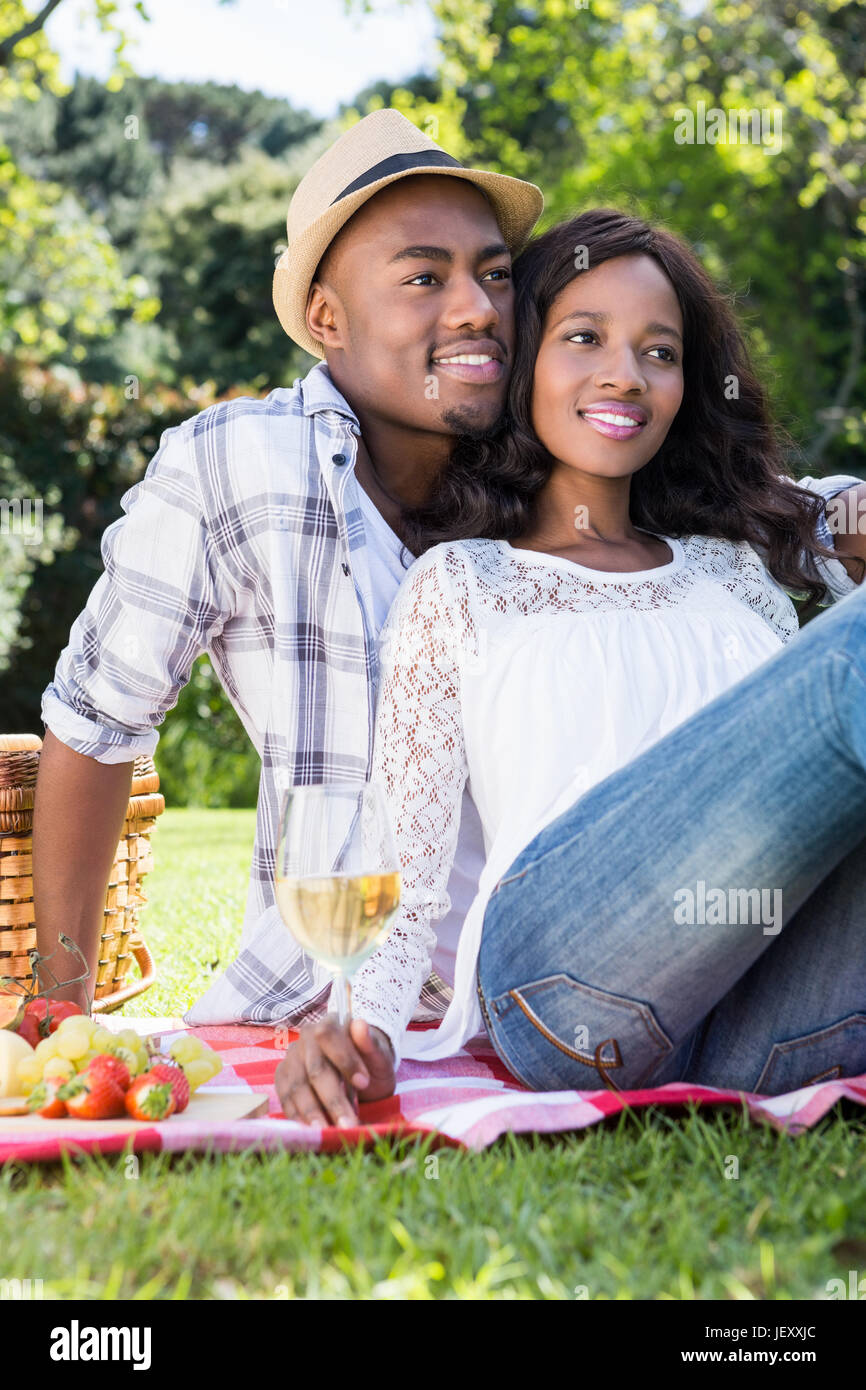 Young couple having a picnic in the park Stock Photo - Alamy