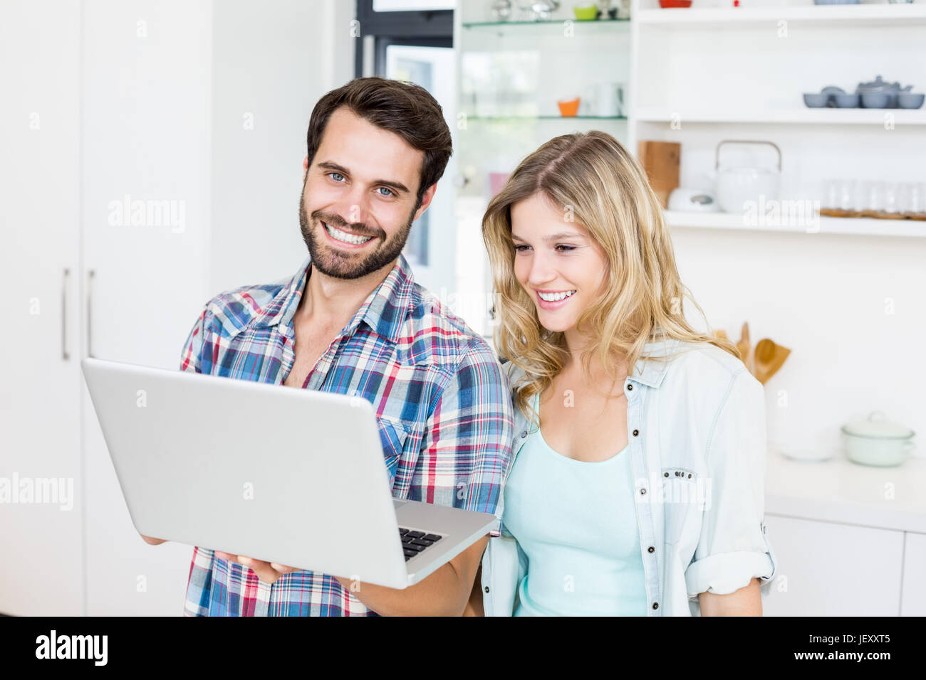 Young couple using laptop Stock Photo - Alamy