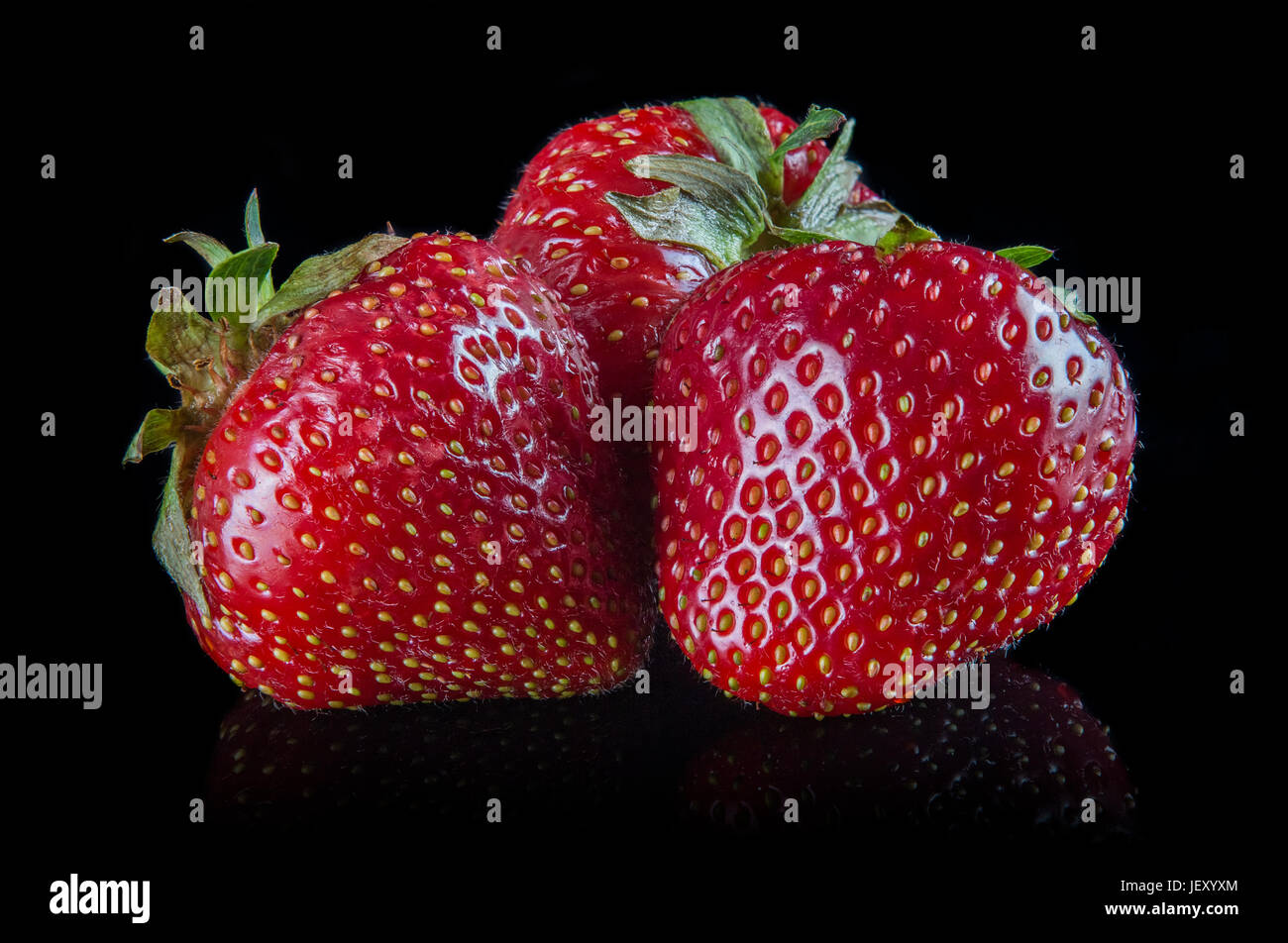 Strawberries with reflection on a black background Stock Photo - Alamy