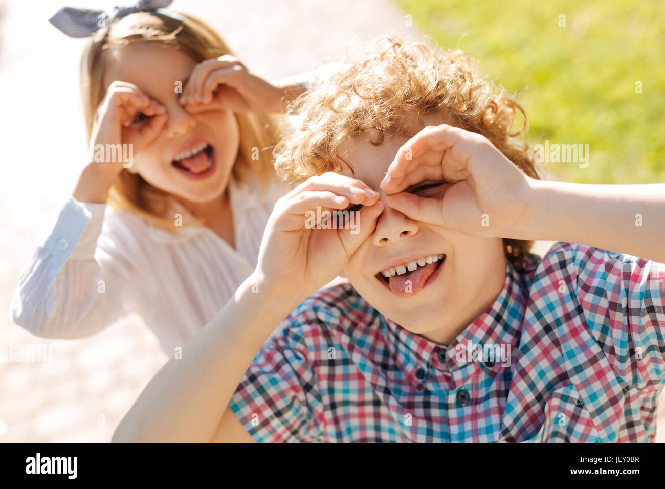 Positive children posing on camera with pleasure Stock Photo