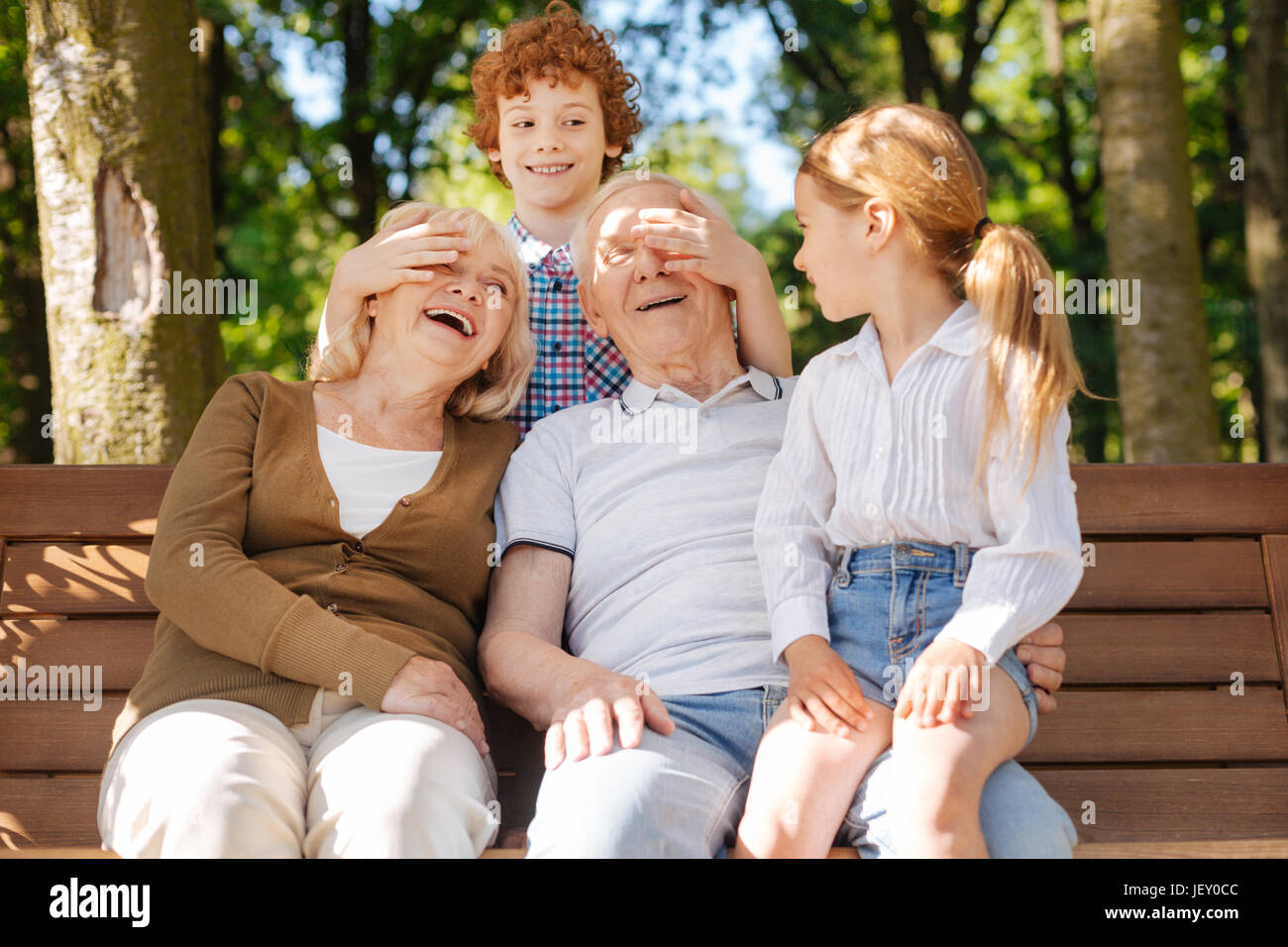 Happy grandparents spending time with children Stock Photo