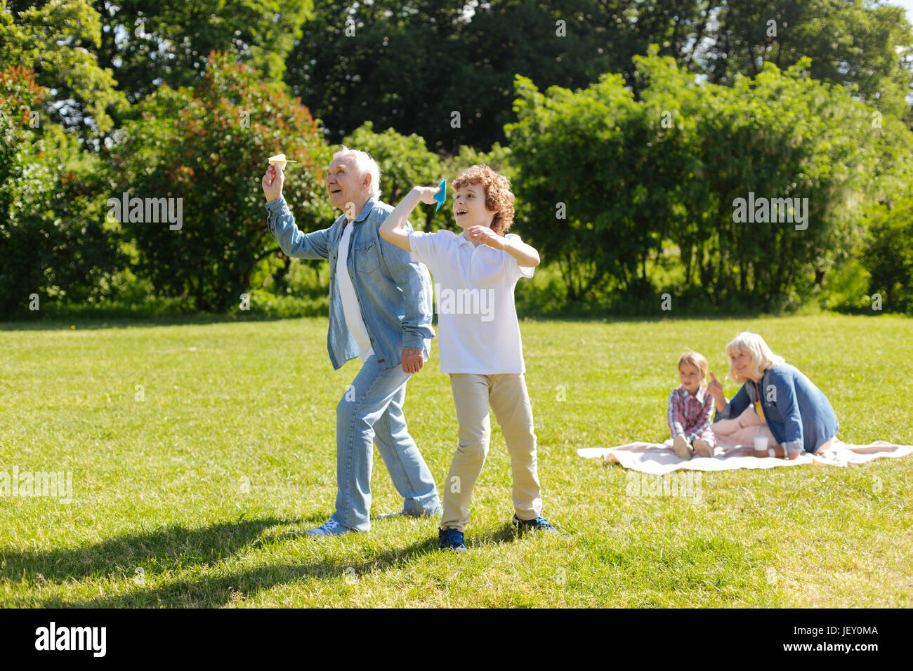 Two generations playing together in park Stock Photo - Alamy