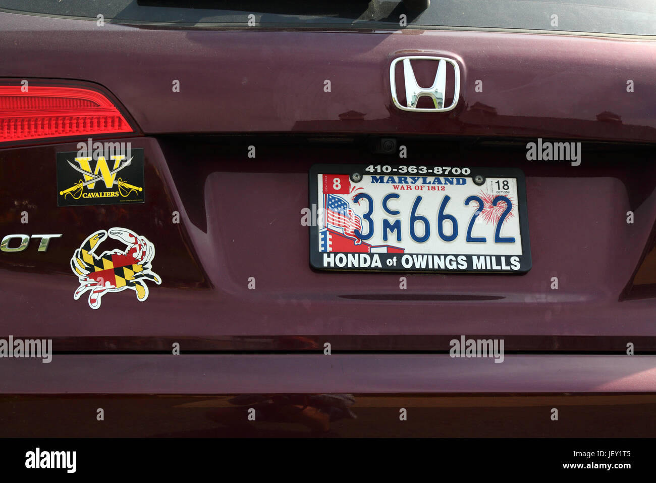 Decorated Maryland state car license plate commemorating War of 1812 and crab shaped sticker with Maryland state flag, USA Stock Photo