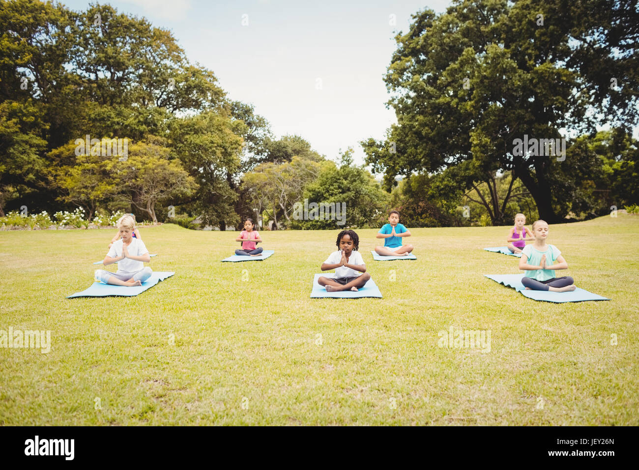 Group of children doing yoga Stock Photo - Alamy