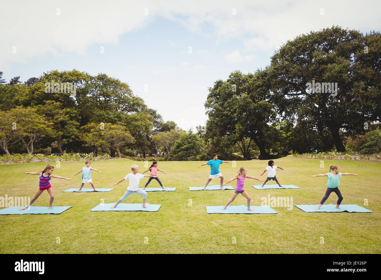Group of children doing yoga Stock Photo - Alamy