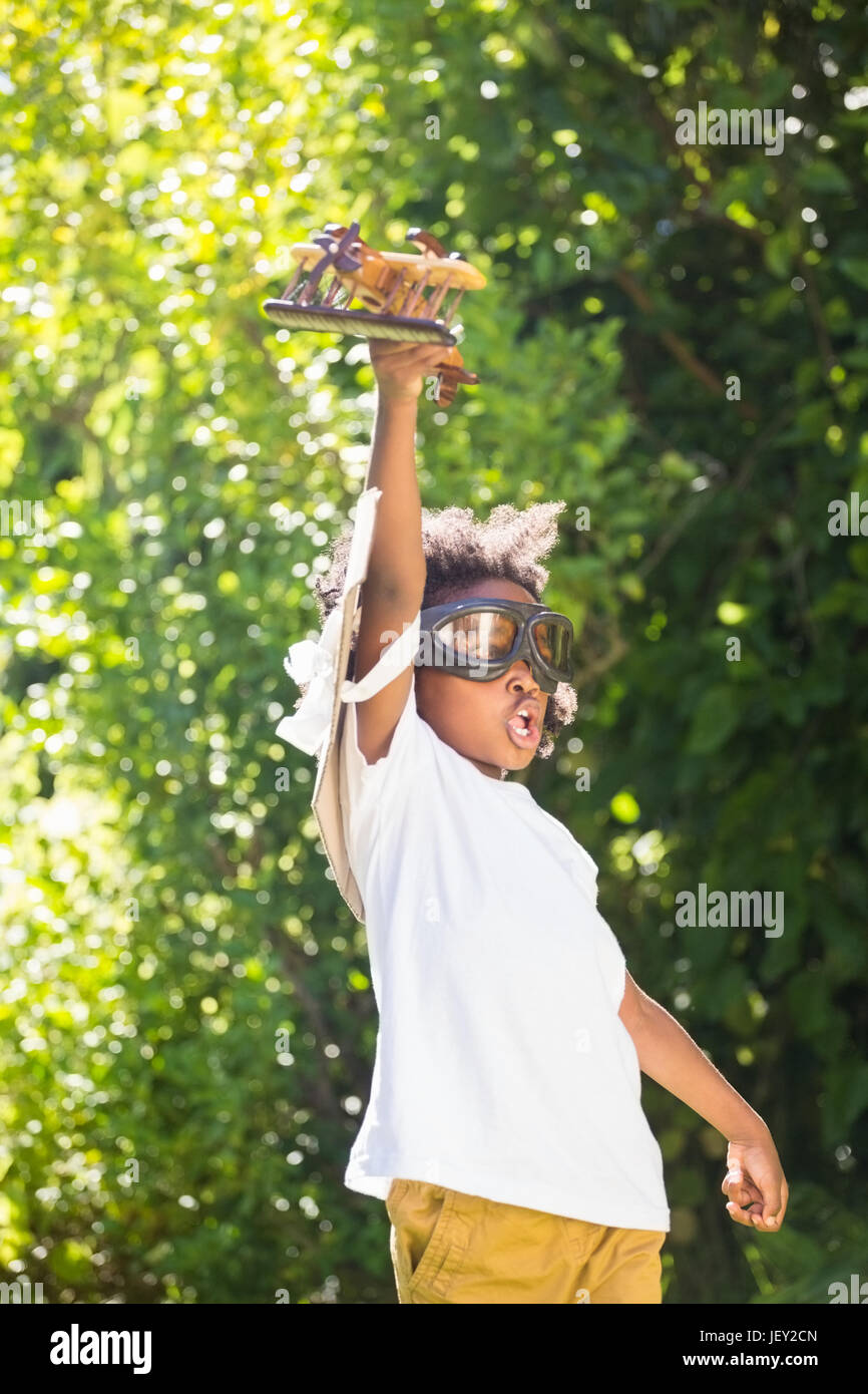 Boy playing with a toy plane at park Stock Photo - Alamy