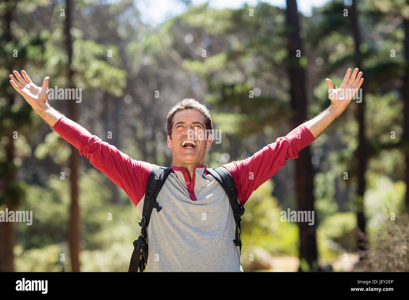 Man smiling and throwing up arms Stock Photo Alamy