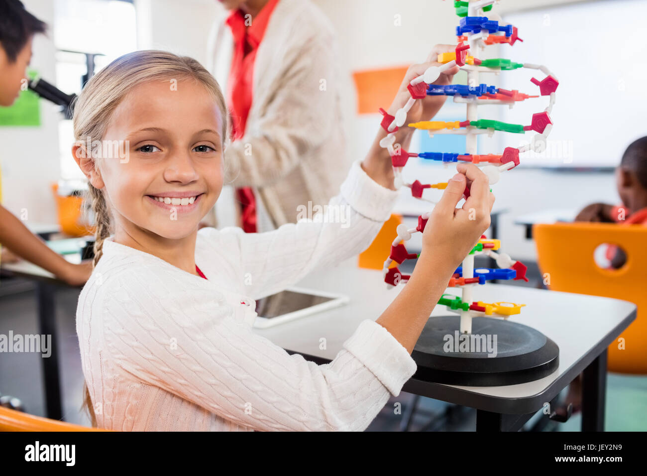 Cute pupil building an atom Stock Photo