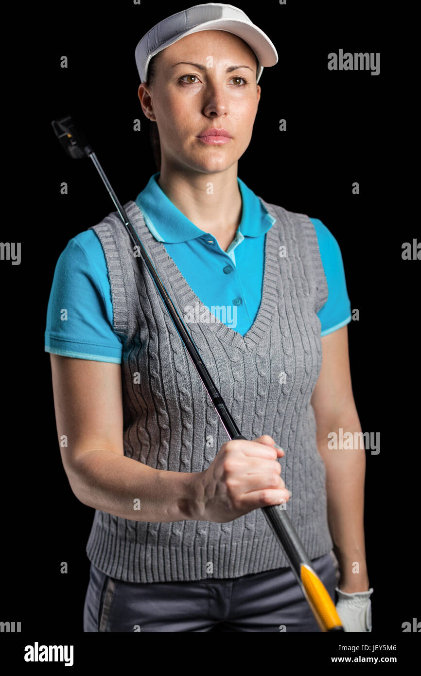 Golf player posing with golf club Stock Photo