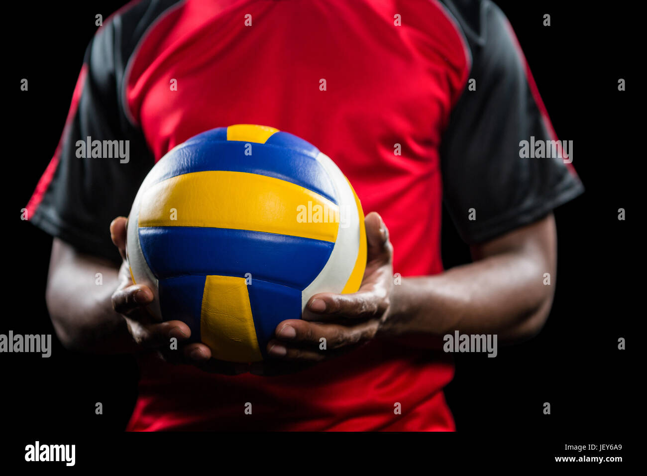 Mid-section of sportsman holding a volleyball Stock Photo