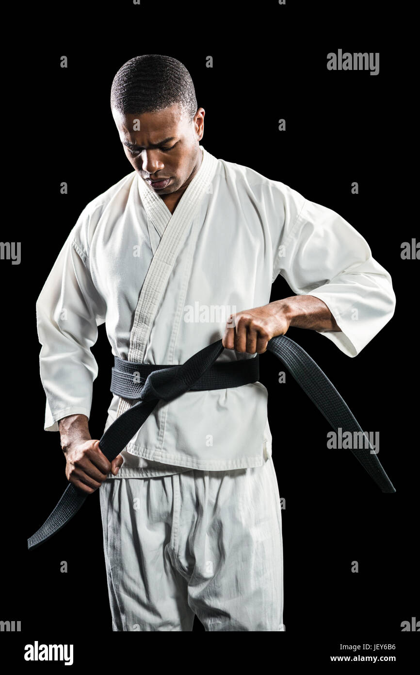 Fighter tightening karate belt Stock Photo Alamy