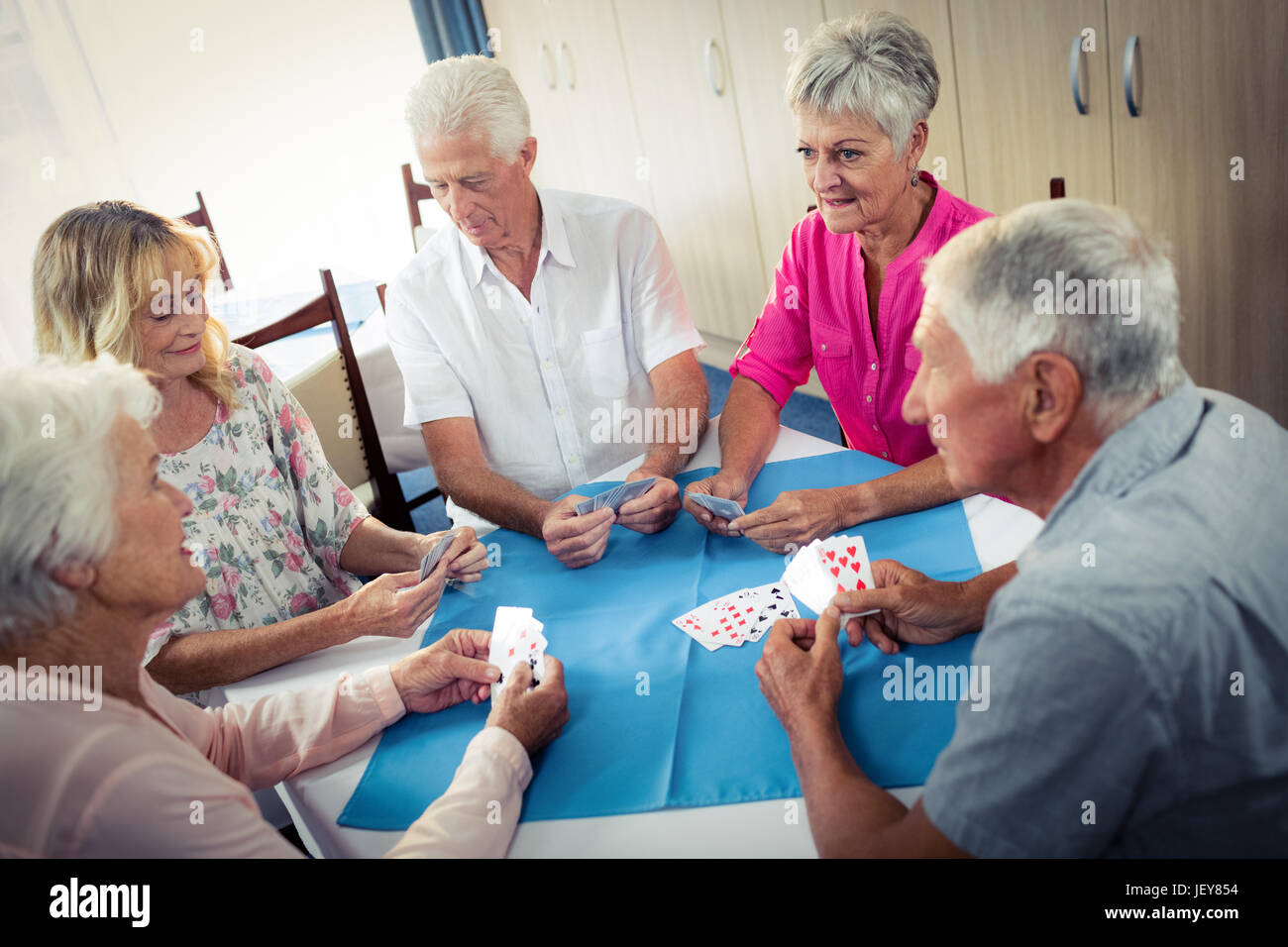 Group of seniors playing cards Stock Photo