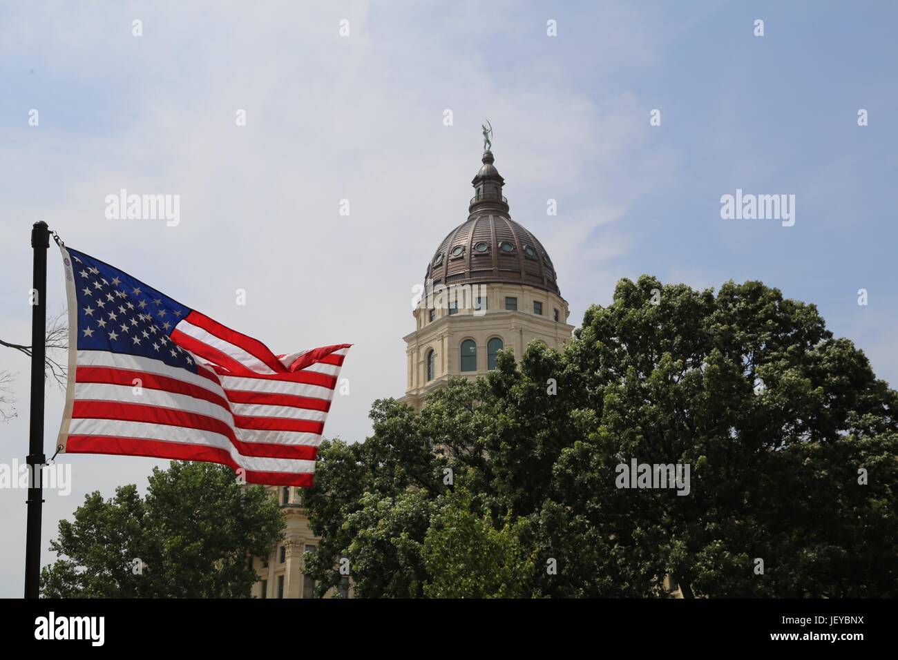 Kansas Capital Building with US Flag Stock Photo