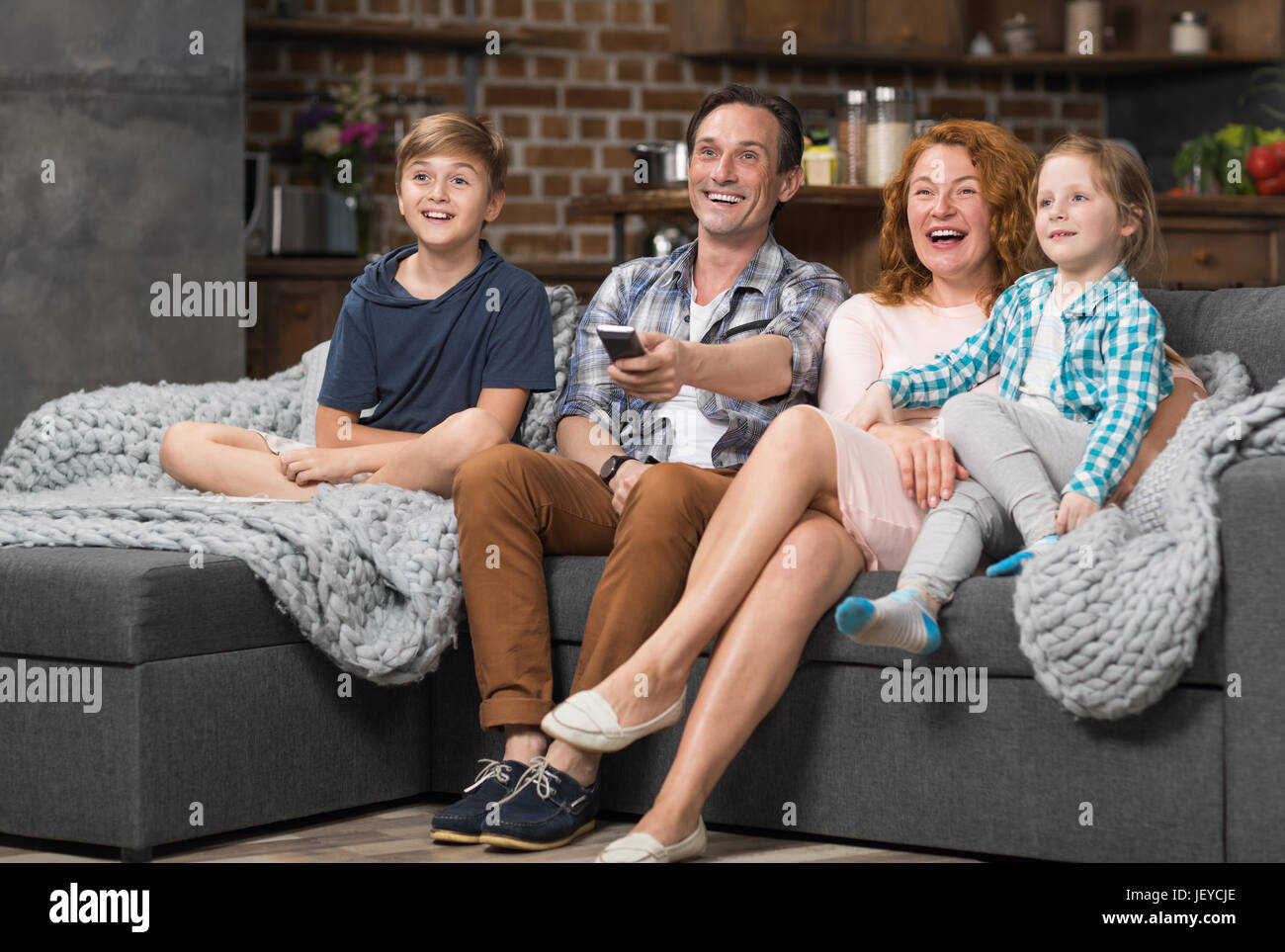 Happy Family Together Spend Time Sitting On Couch Watching Tv