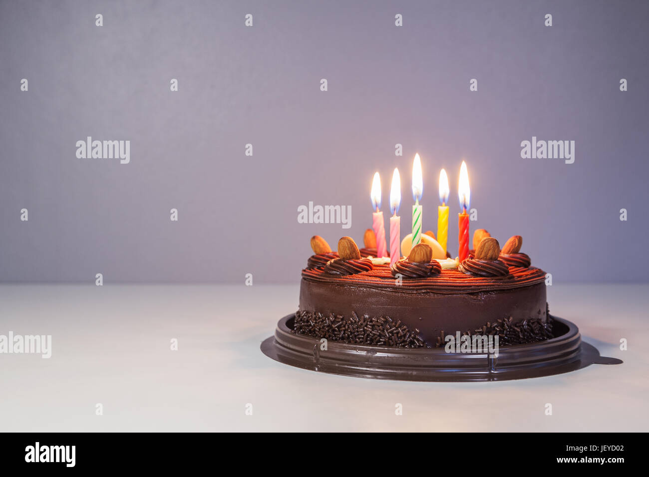 White chocolate frosted happy birthday cake candles hi-res stock ...