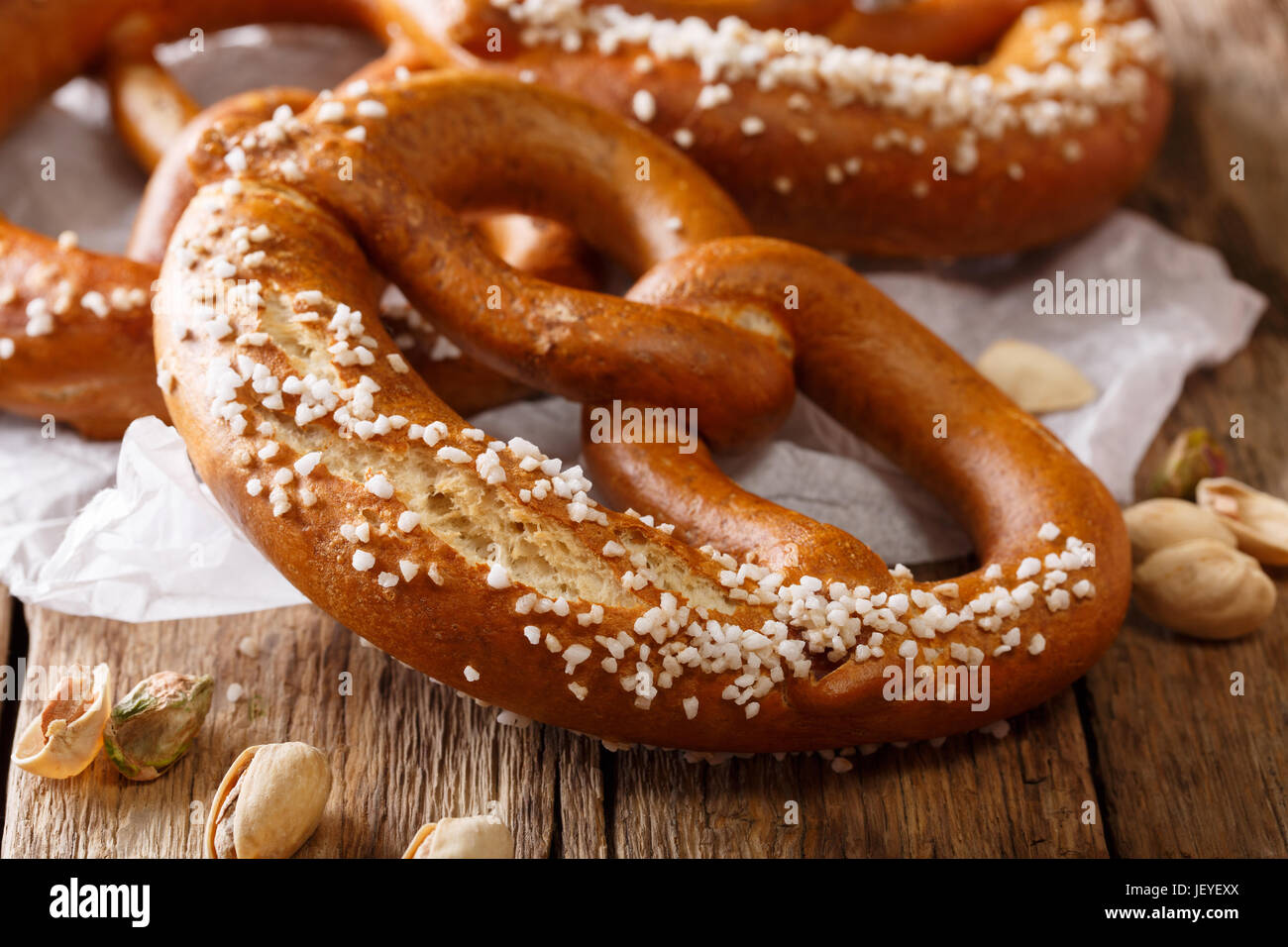 German meal: salted bread pretzel and pistachio close-up on the table ...