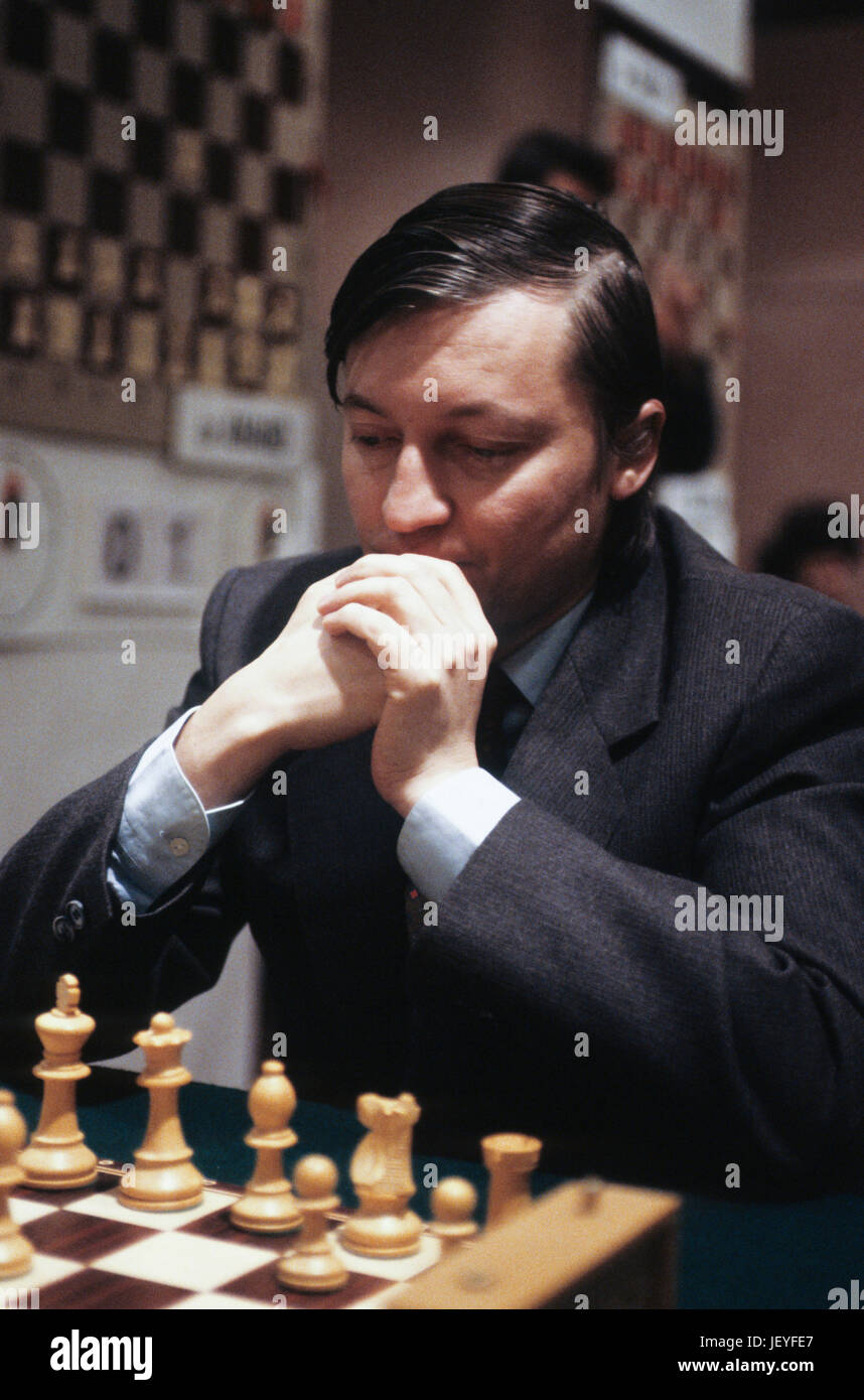 Russian chess grandmasters Boris Spassky, right, and Anatoly Karpov, left,  shake hands the news