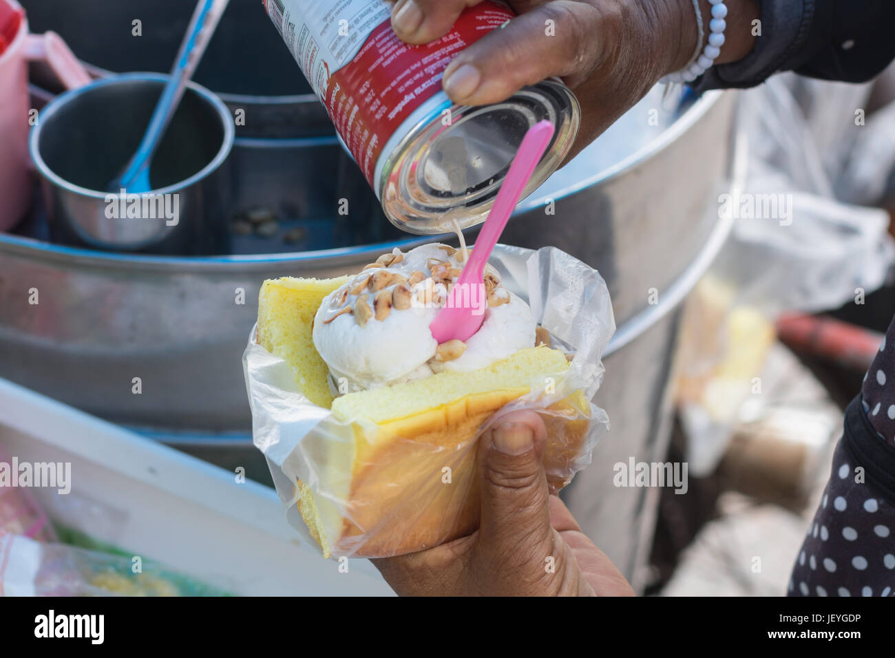 Coconut ice-cream on bread topping with peanut.Famous summer street dessert in Thailand Stock Photo