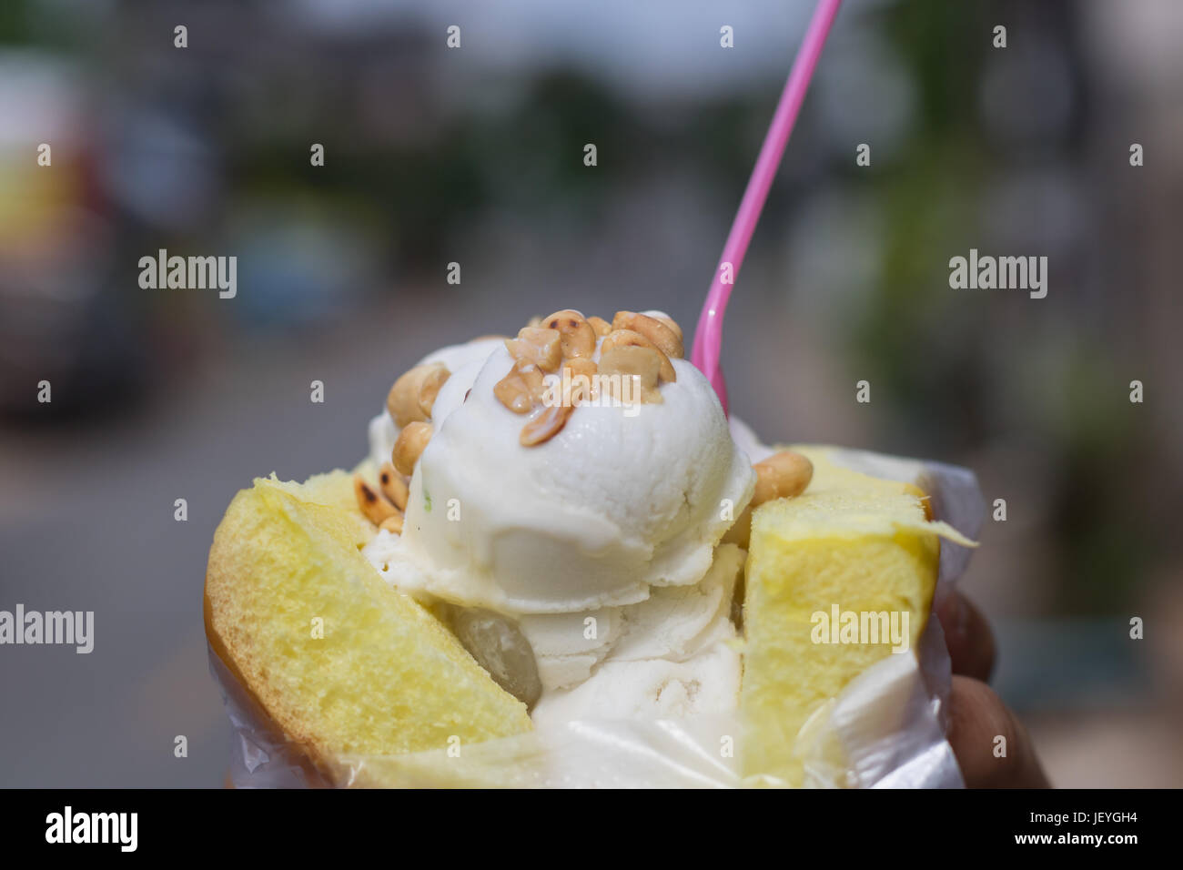 Coconut ice-cream on bread topping with peanut.Famous summer street dessert in Thailand Stock Photo