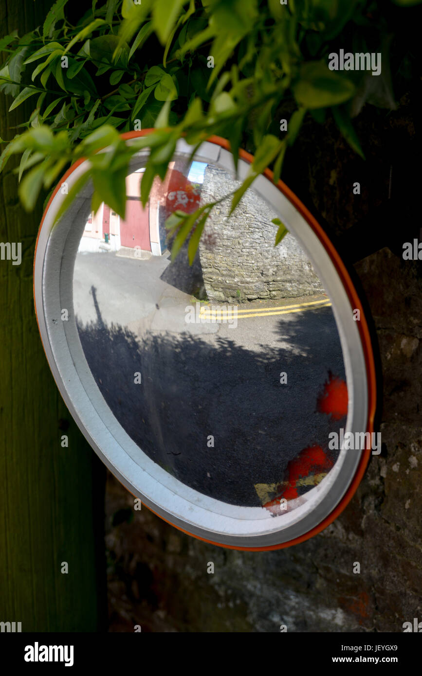 Covex circular mirror mounted to wall. Stock Photo