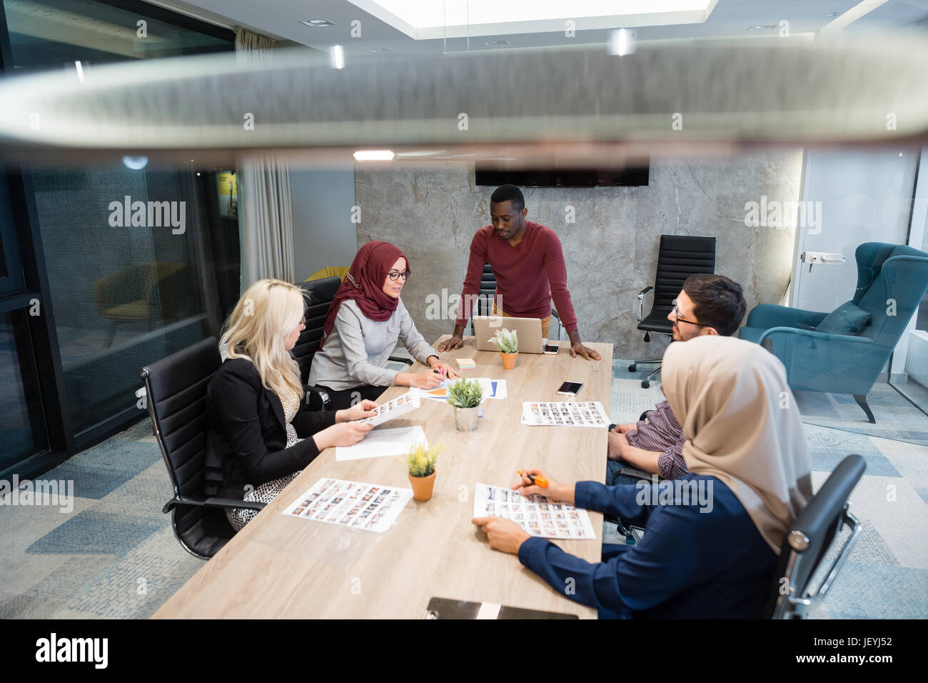 Multi-Cultural Office Staff Sitting Having Meeting Together Stock Photo ...