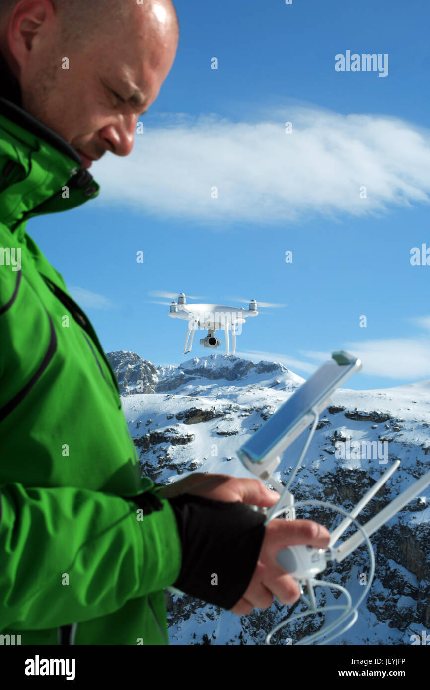 Man hands handling drone in winter Alpine landscape panorama Stock ...
