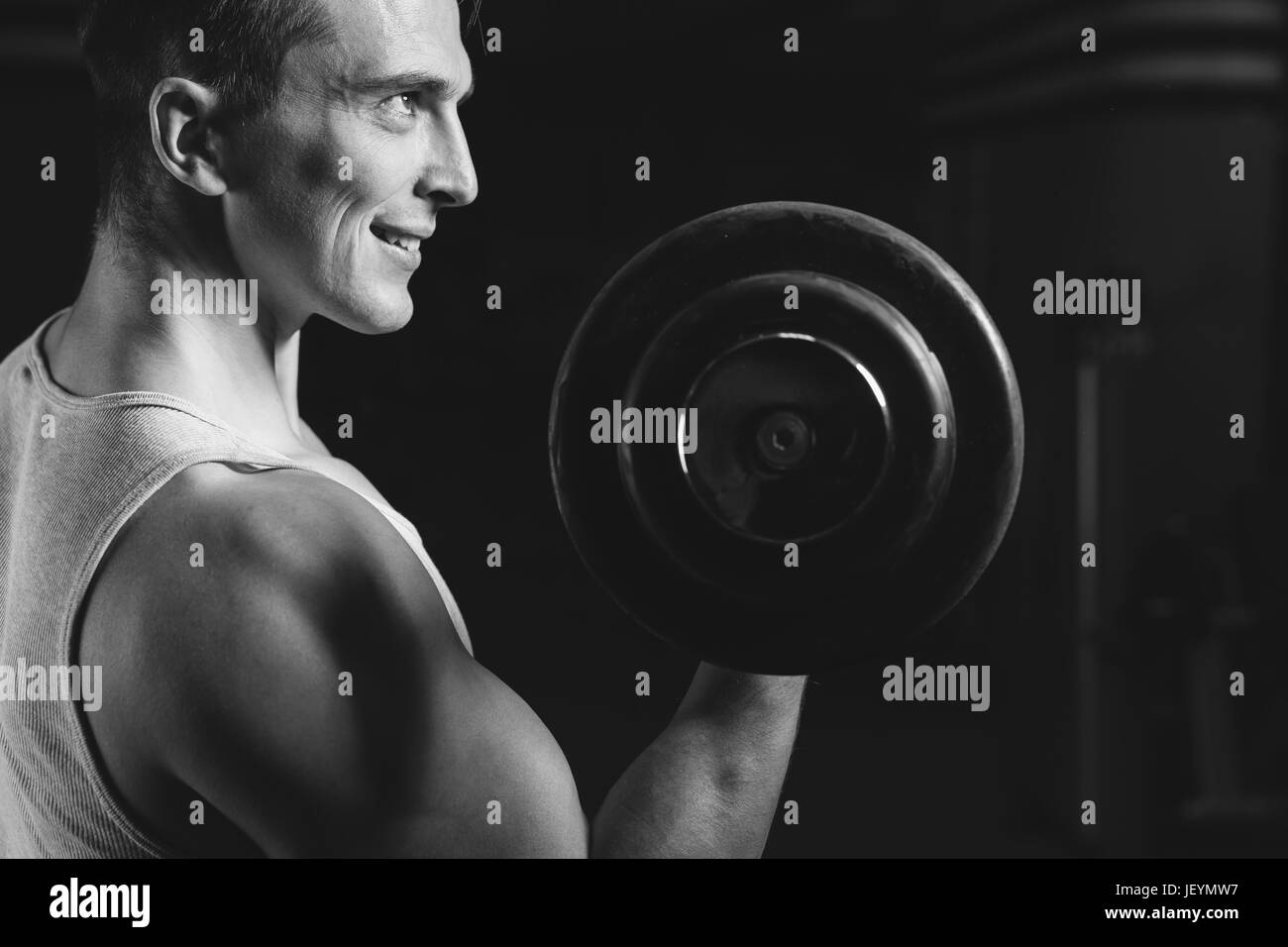 Closeup portrait of a muscular man workout with barbell at gym.  Deadlift barbells workout. Stock Photo