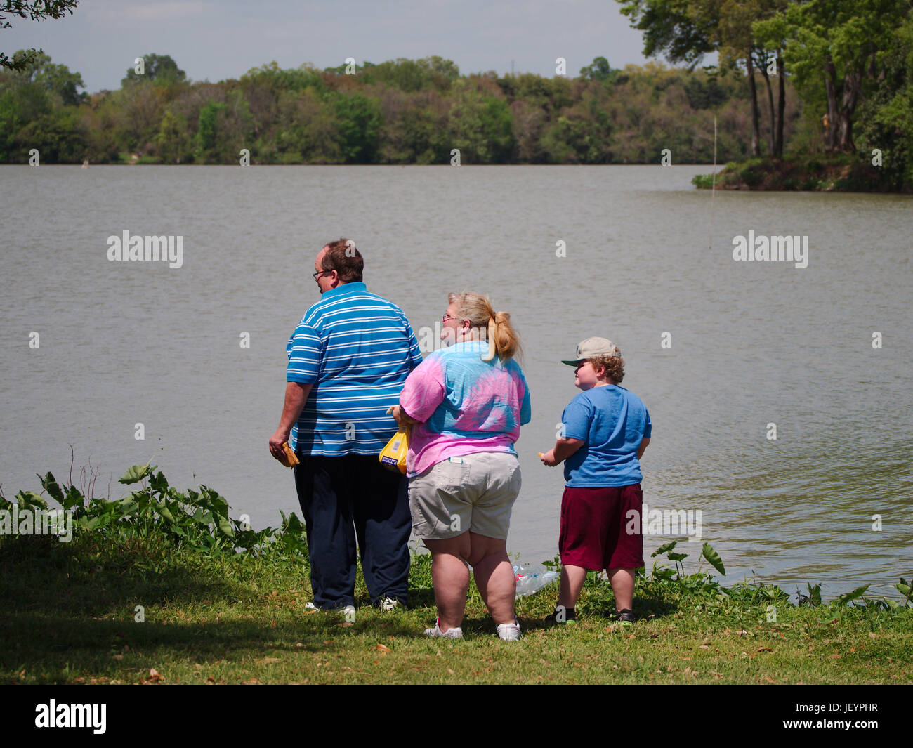 BATON ROUGE, LOUISIANA - 2011: Obese family stands by University Lake near Louisiana State University. Stock Photo