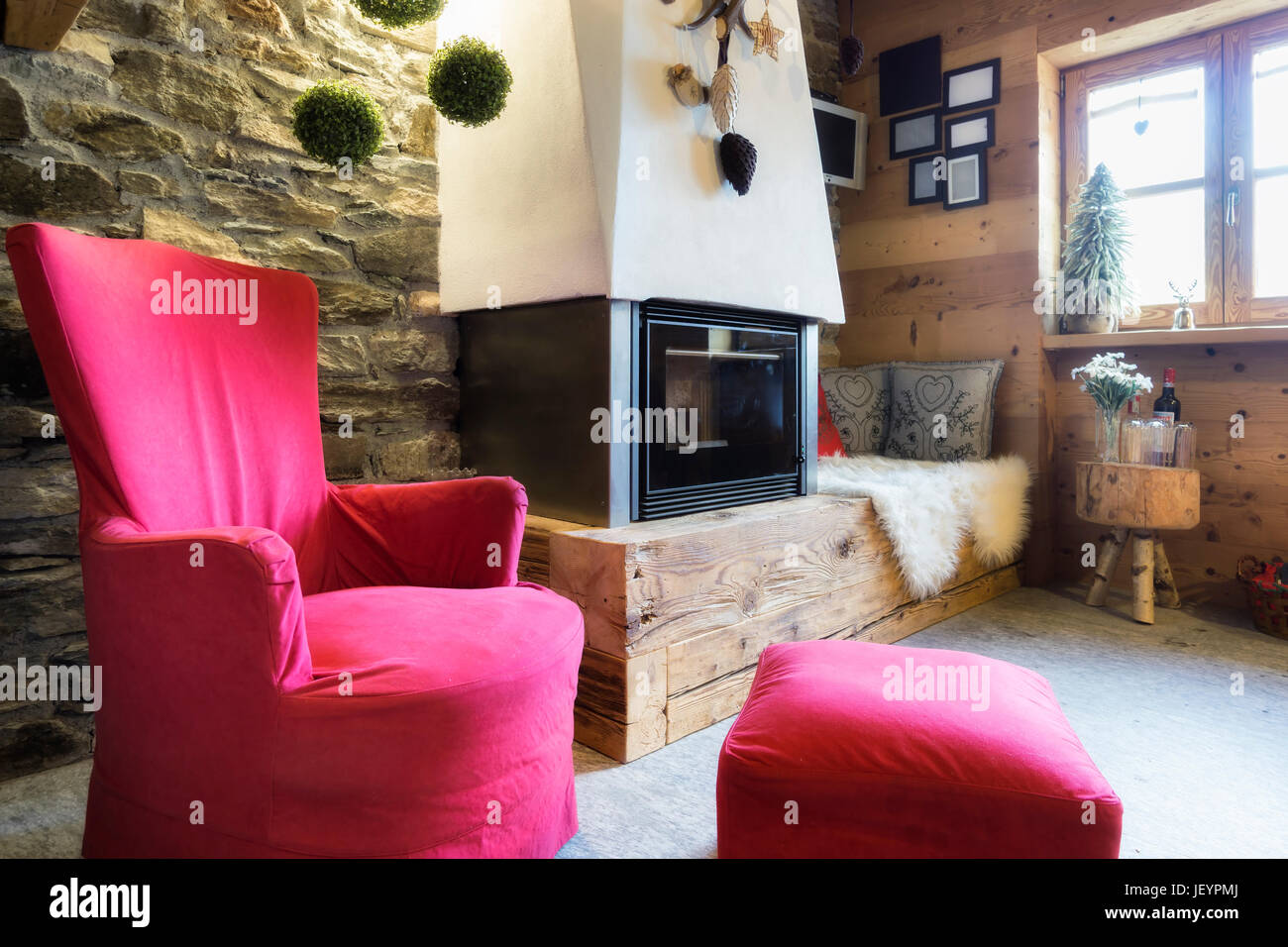 Cozy interior of a rustic chalet with modern fireplace Stock Photo