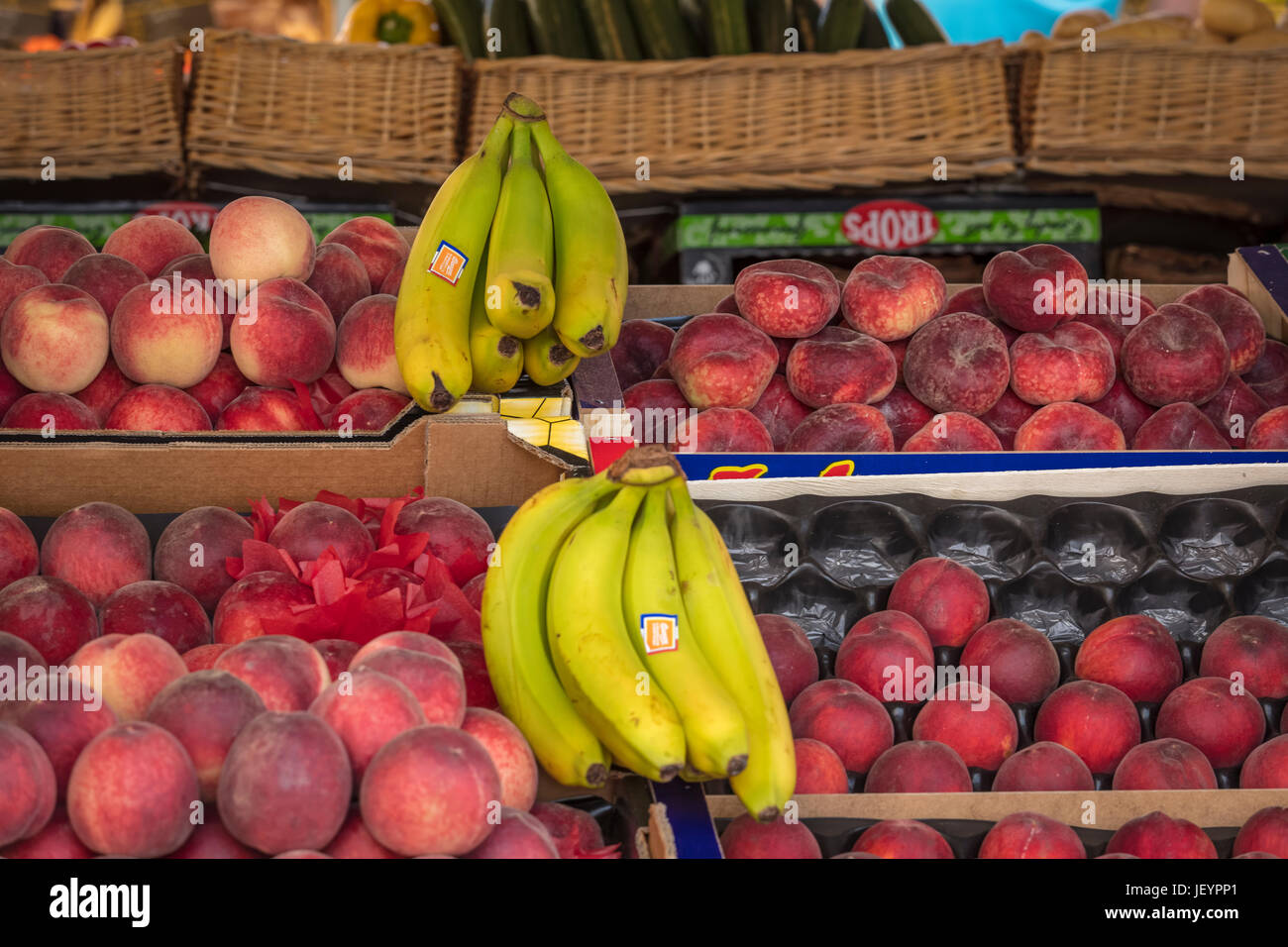 French peaches and bananas on a market stall Stock Photo Alamy