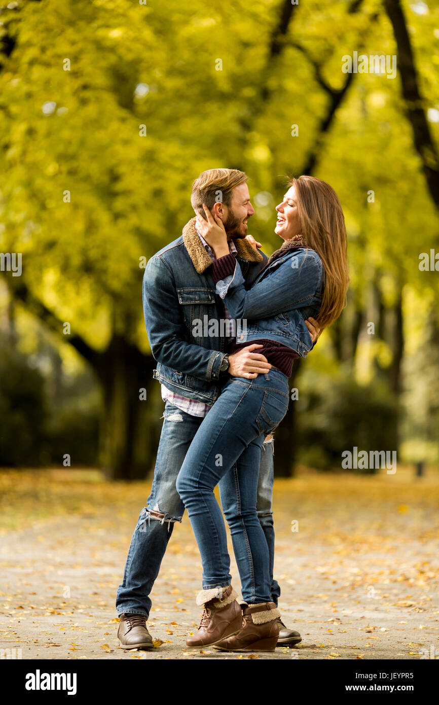 View at smiling couple hugging in autumn park Stock Photo - Alamy