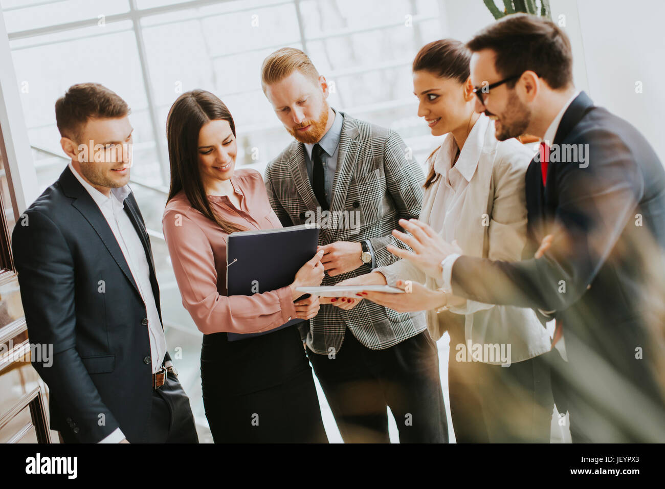 Group of businesspeople standing in the modern office Stock Photo - Alamy