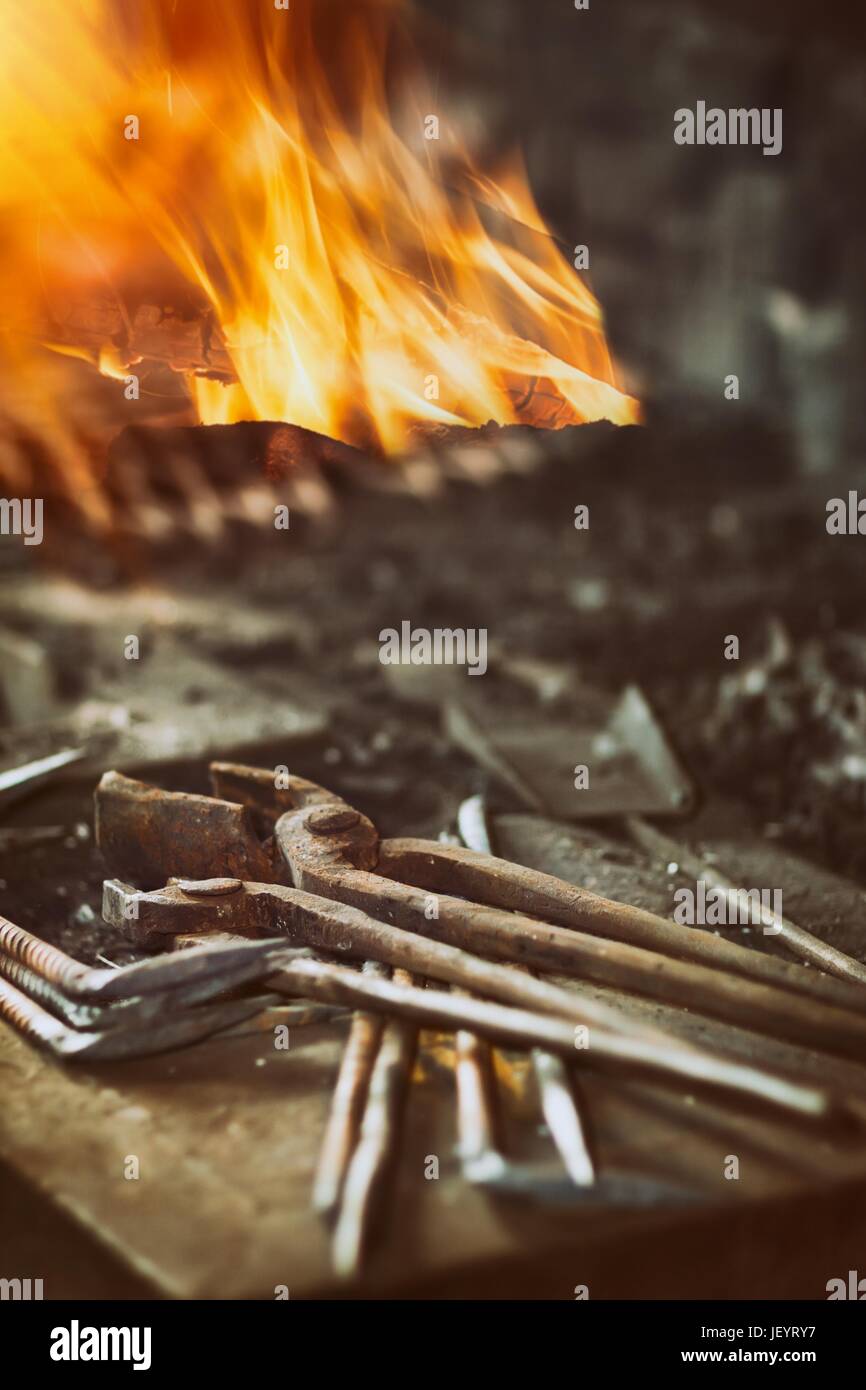 Blacksmith tools in the background with fire Stock Photo