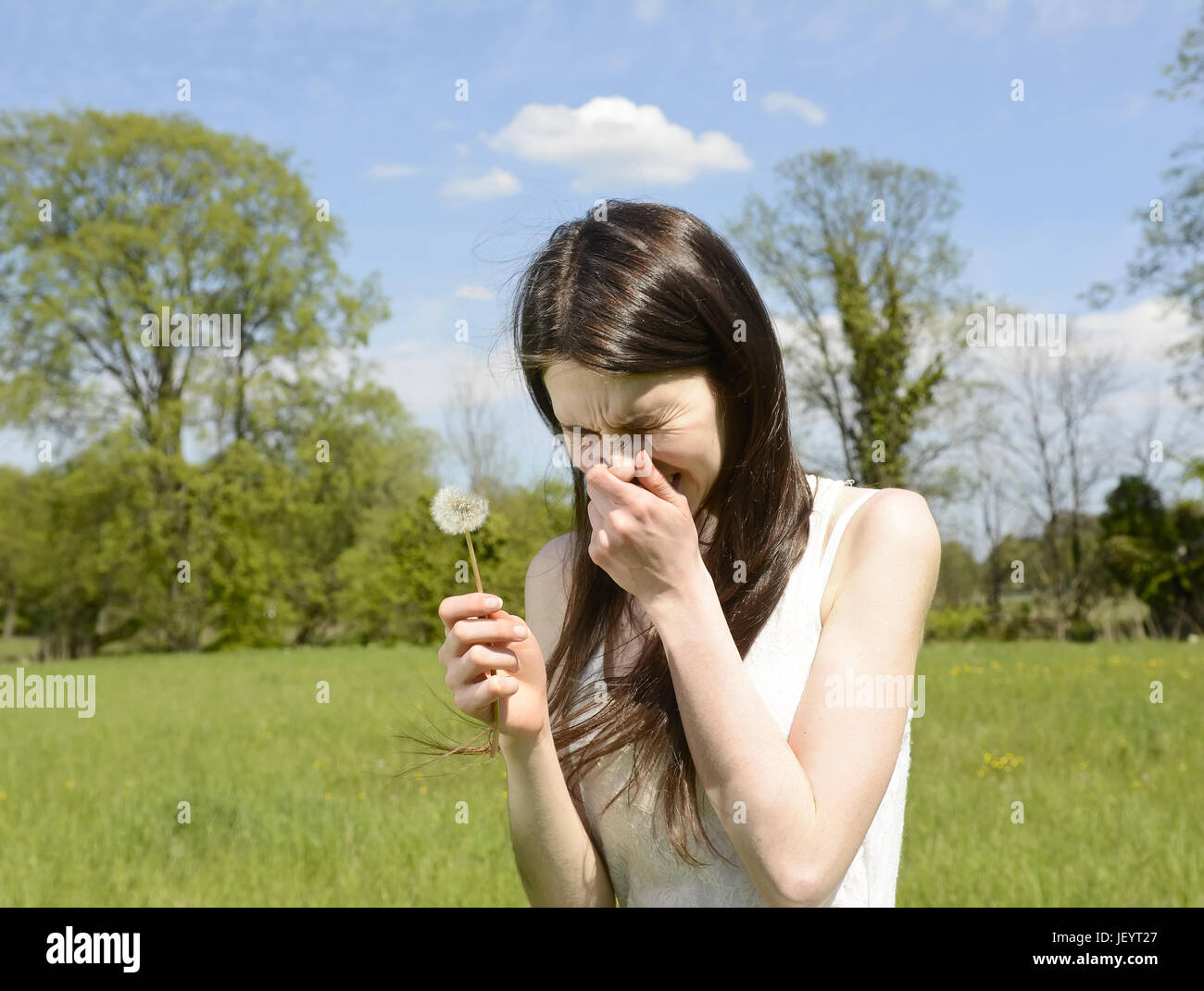 young woman sneezes Stock Photo