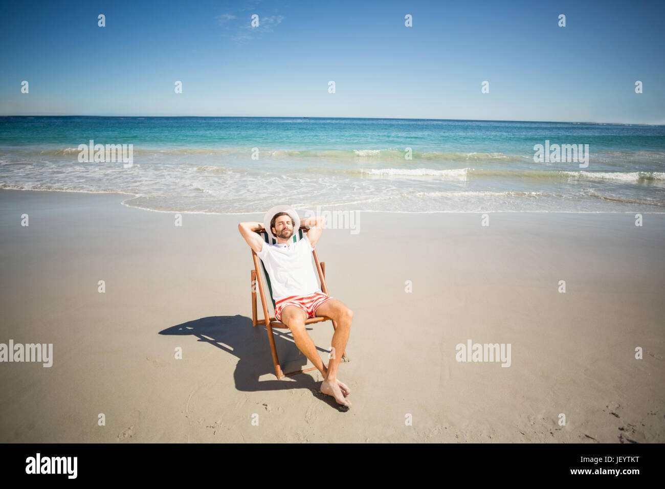 Man relaxing on armchair Stock Photo Alamy