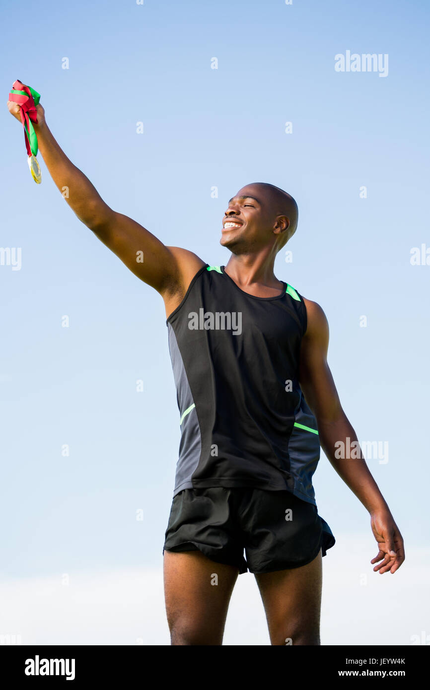 Athlete posing with gold medal after victory Stock Photo - Alamy