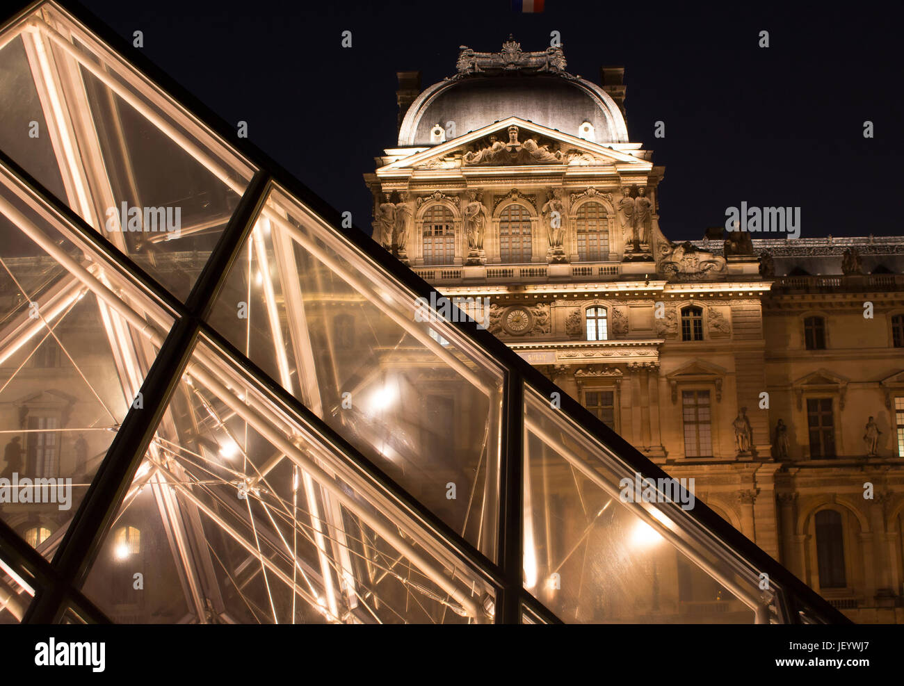 Night view of glass pyramid at Louvre Museum (Musée du Louvre). Former historic palace housing huge art collection, from Roman sculptures to da Vinci' Stock Photo