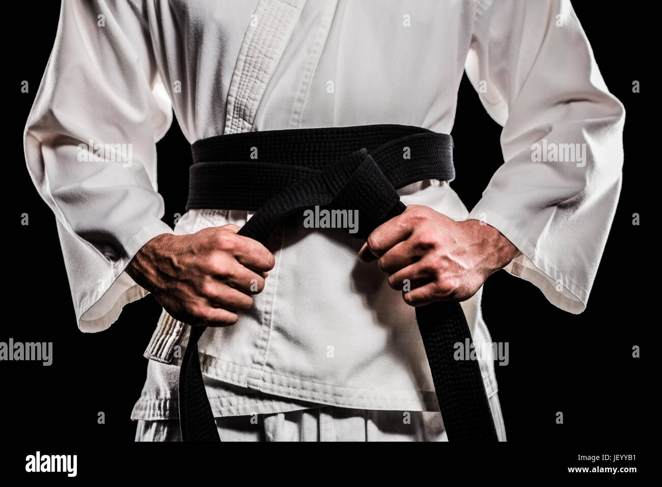 Fighter tightening karate belt Stock Photo Alamy