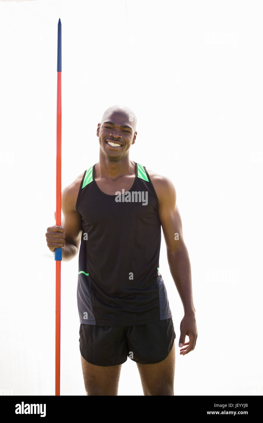 Happy athlete standing with javelin Stock Photo Alamy