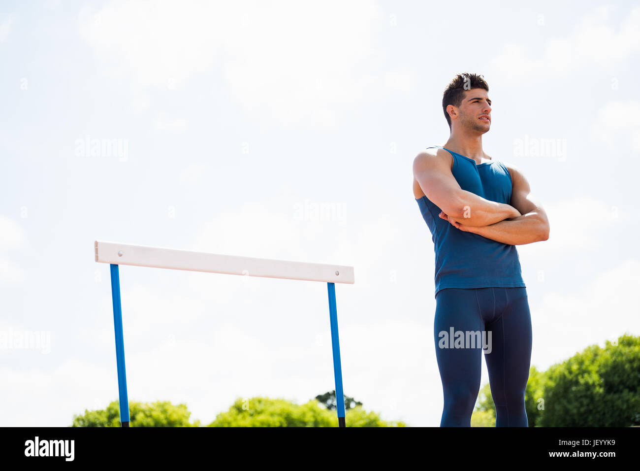 Athlete standing with arms crossed Stock Photo