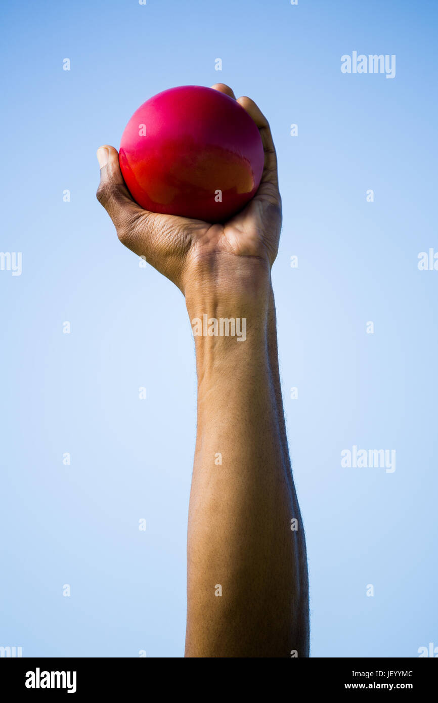 Athletes hand holding shot put ball Stock Photo Alamy