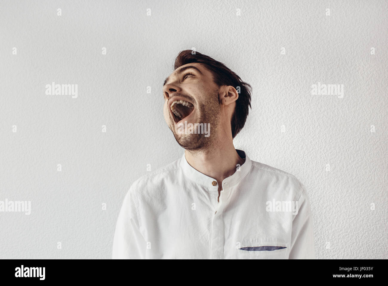 Man standing and yelling with an open mouth Stock Photo