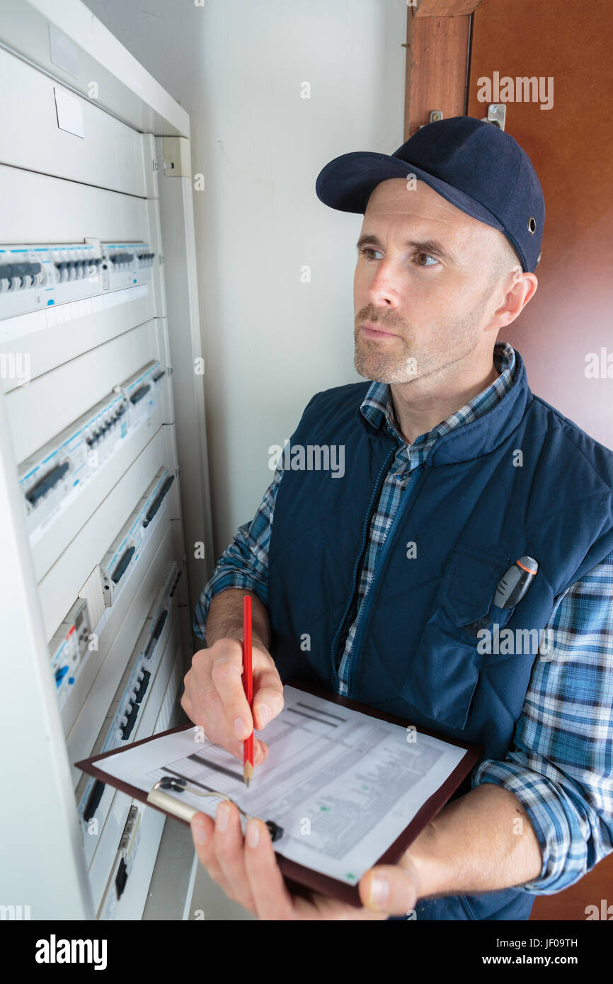 Electrical inspector by fusebox Stock Photo Alamy