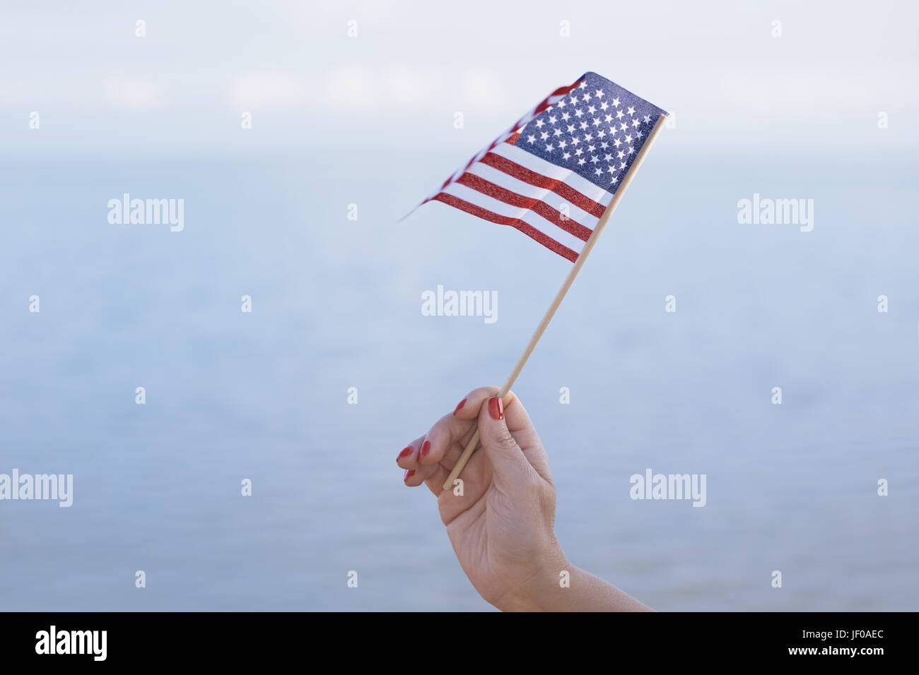 Woman waving american flag hi-res stock photography and images - Alamy