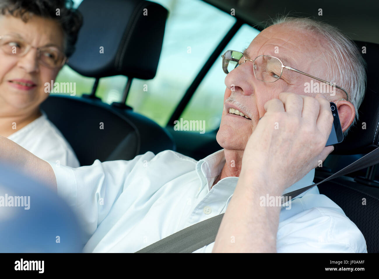 Elderly man on telephone while driving Stock Photo