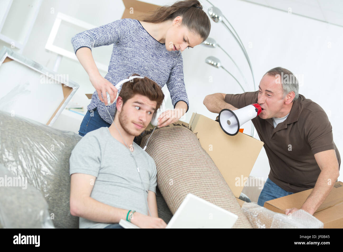 Man shouting at teenager through loudhailer Stock Photo