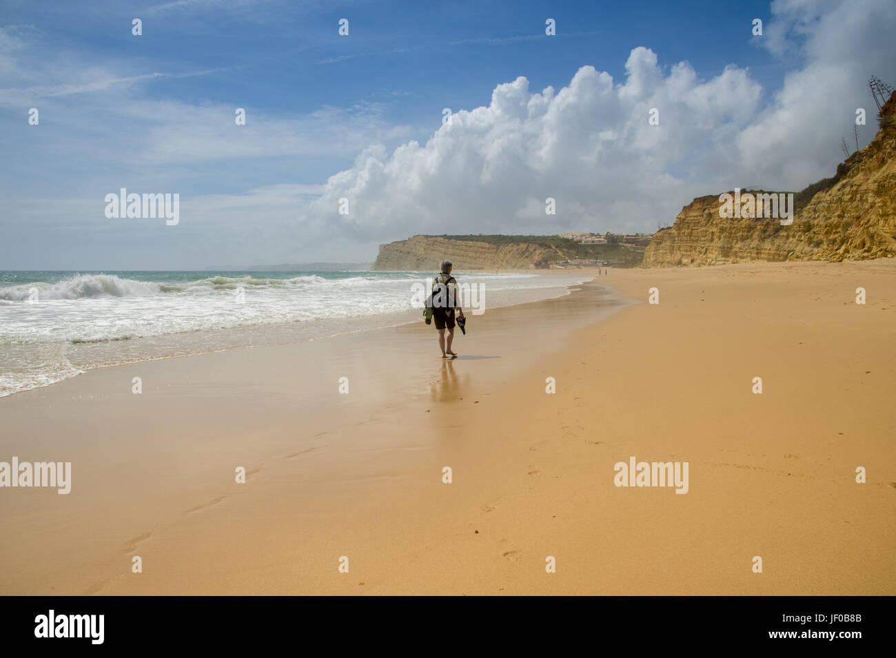 A woman travels alone on the beach Stock Photo