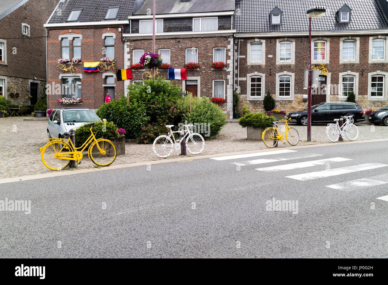 HENRI-CHAPELLE, BELGIUM, 25th JUNE, 2017 - painted bicycles fixed on a pole near a street Stock Photo