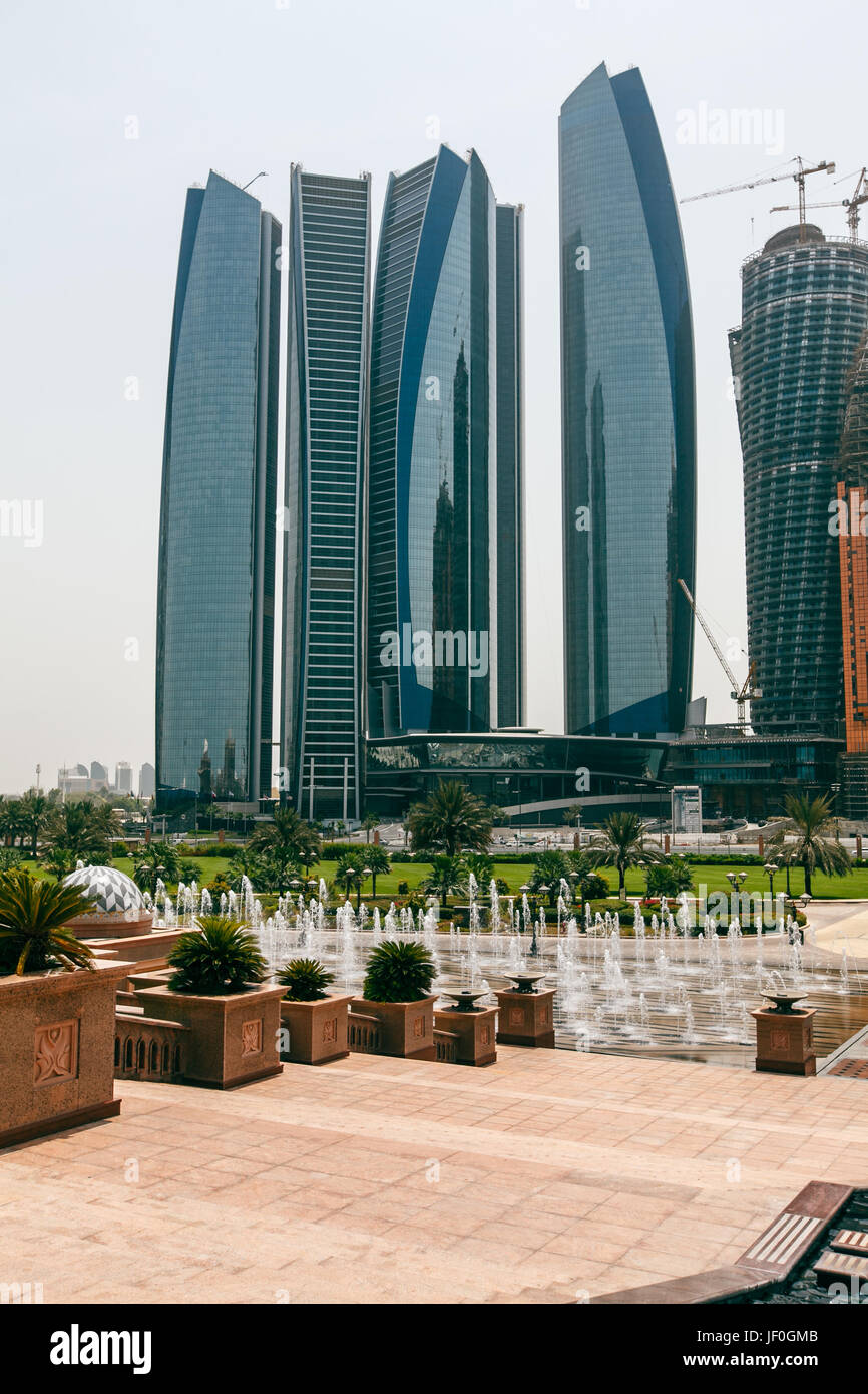 Panorama of tall Skyscrapers in skyline of Emirates against blue sky. Stock Photo