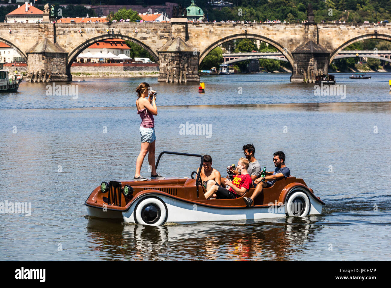 Prague Tourists on Prague pedal boat Vltava River back Charles Bridge Prague summer day Czech Republic tourism Vltava in Prague Stock Photo